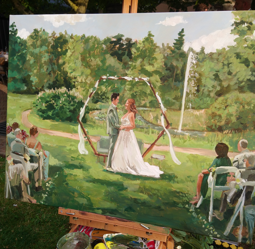 Photo of painting on easle, green outdoor wedding in front of backdrop and pond